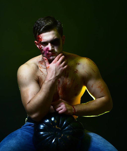 Macho with torso touches chin. Halloween and party concept. - Foto, imagen