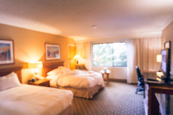 Vintage tone motion blurred typical double room with windows, flat-screen TVs in American hotel - Photo, Image