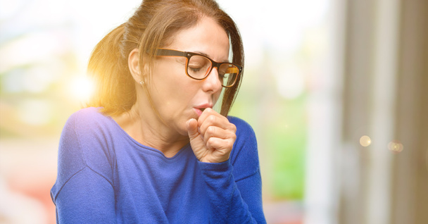 Średnim wieku kobieta nosi sweter wełniany i okulary chory i kaszel, cierpiących astmę lub zapalenie oskrzeli, koncepcja medycyna - Zdjęcie, obraz