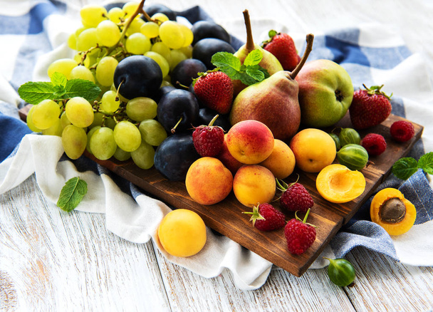 Fresh summer fruits on a old wooden table - Фото, зображення