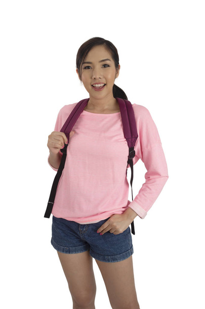 Portrait of beauty asian girl in pink t-shirt and blue jean shorts with backpack in studio. - Фото, изображение