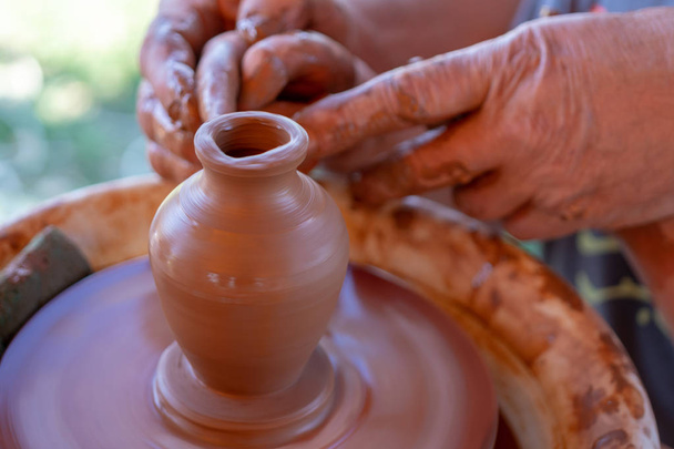 The master's hands make a pot on the potter's wheel. - Photo, Image