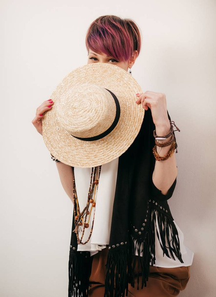 Portrait of beautiful young  woman posing with straw hat - 写真・画像