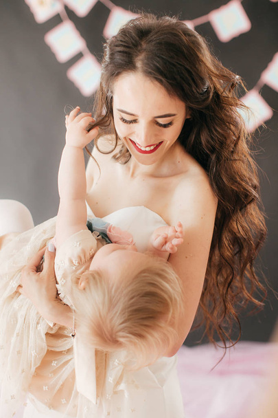 Happy mother with cute daughter in room on Birthday party. - Foto, imagen