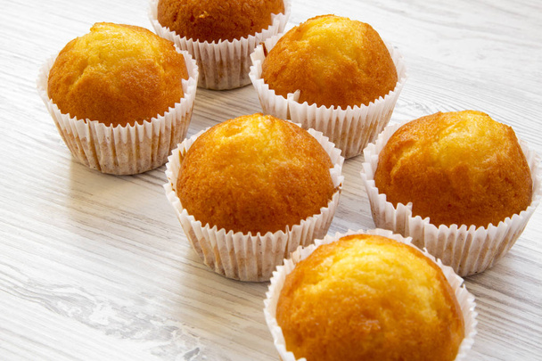 Fresh muffins on a white wooden table, side view. Close-up. - Photo, Image