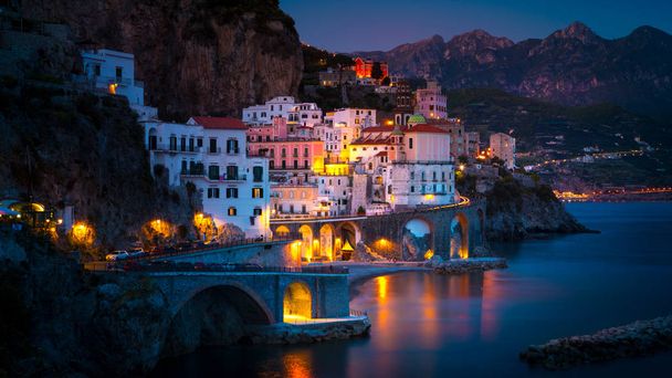 Vista nocturna de Amalfi en la costa del mar Mediterráneo, Italia
 - Foto, Imagen