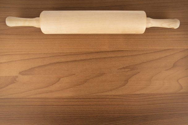 Rolling pin on wooden table, directly above. Copy space for your text below. - Photo, Image