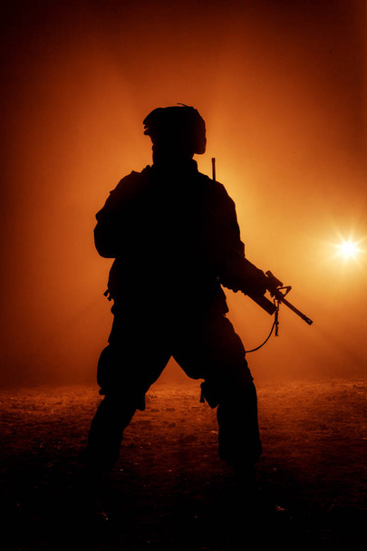 Soldiers silhouette on background of fire explosion - Photo, Image