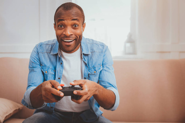 Cheerful young man playing games - Foto, imagen