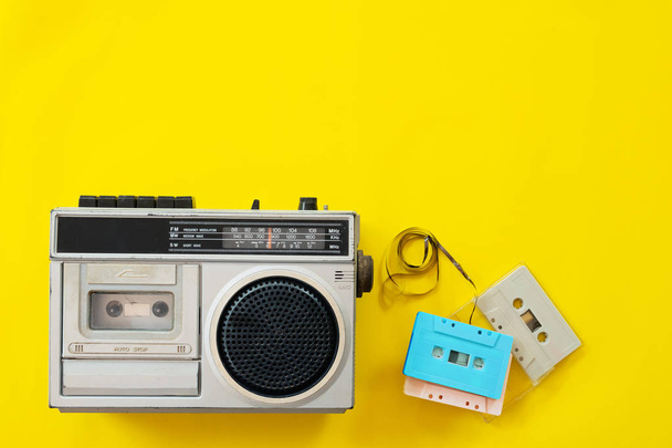 vintage radio and cassette player on yellow background, flat lay, top view. retro technology - Foto, Bild