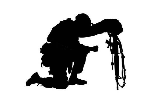 Sad soldier kneeling because of friend death - Photo, Image