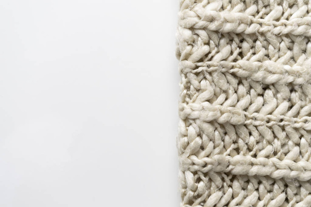 Wool blanket, white, knitted large chunky yarn. Close-up of knitted blanket on white background. - Photo, Image