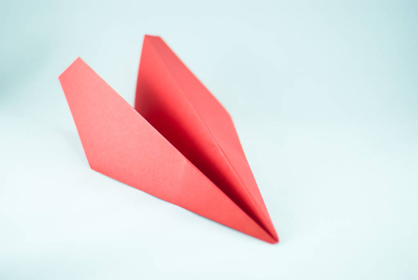 Red paper plane on a white background, isolated. Concept (idea) of airlines, freedom, leadership, success, and creativity - Photo, Image