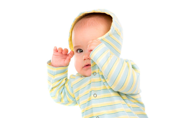 Little Baby isolated on white background. The baby hides his face behind the hood. Hiding from danger. - Valokuva, kuva