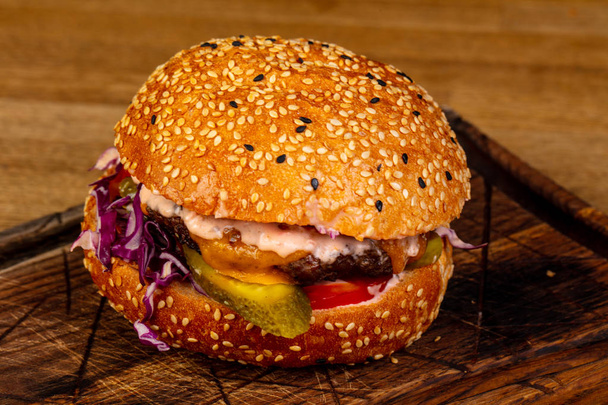 Tasty burger with meat and cheese - Fotó, kép
