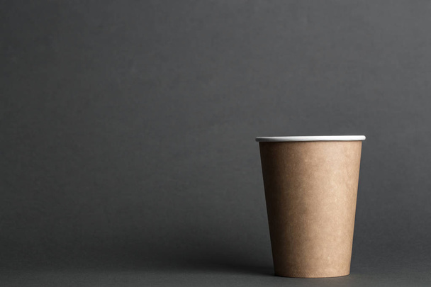 coffee to go in a disposable cup on a black background, place for tex - Фото, зображення