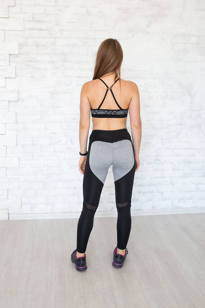 Rear view of sportive woman wearing sexy leggings and top. Back view of sporty woman. Fitness model  - Φωτογραφία, εικόνα