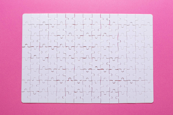 White puzzle on pink background. Missing piece. Top view - Fotó, kép