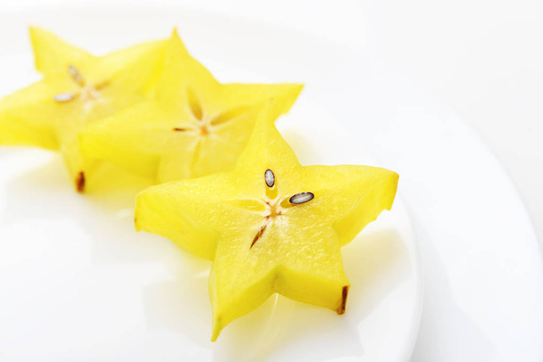 Carambola fruit (starfruit) slices on plate closeup - Photo, image