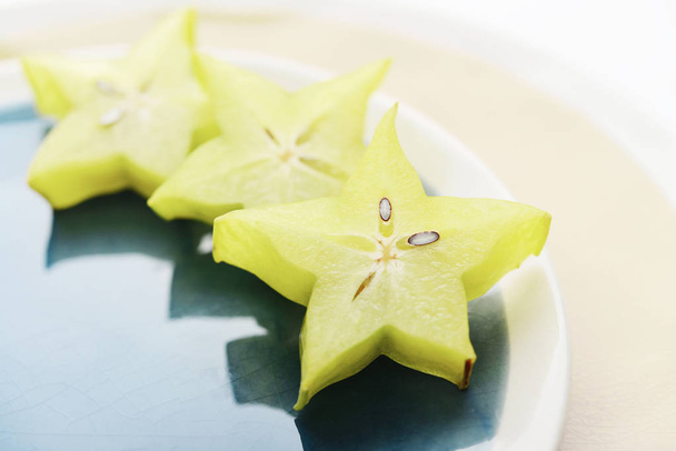 Carambola fruit (starfruit) slices on plate closeup - Photo, image