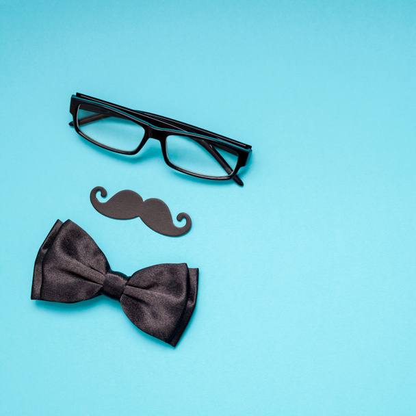 Creative square flatlay overhead top view retro black paper photo booth props moustaches turquoise background copy space. Men health awareness month fathers day masculinity concept blog social media - Fotoğraf, Görsel