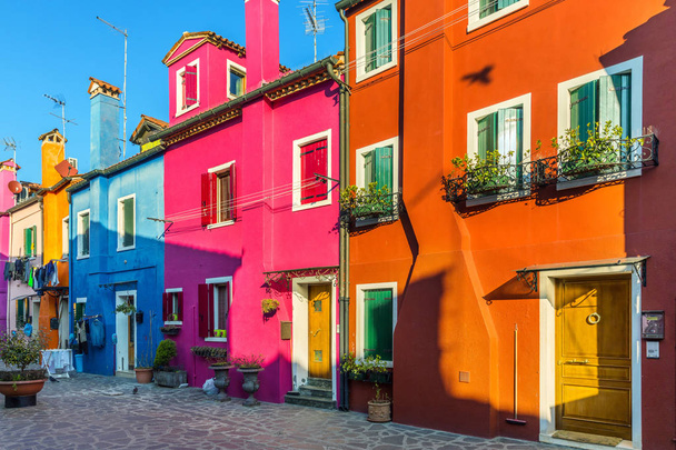 Beautiful view of the canals of Burano with boats and beautiful, colorful buildings. Burano village is famous for its colorful houses. Venice, Italy. - Photo, Image