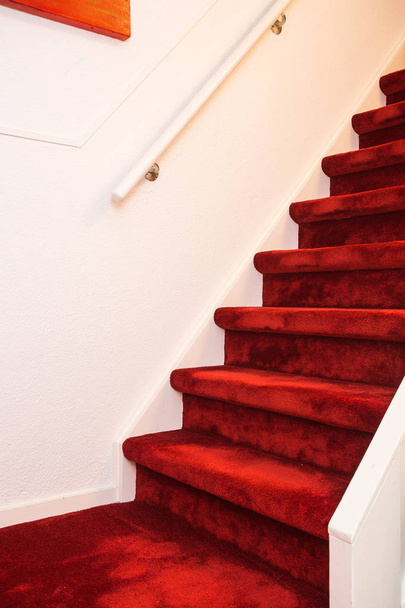 Modern fedett márvány lépcsőház, a vörös szőnyegen. - Fotó, kép