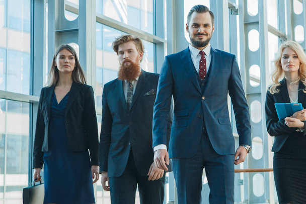 Business team walking in modern glass office building - Foto, immagini