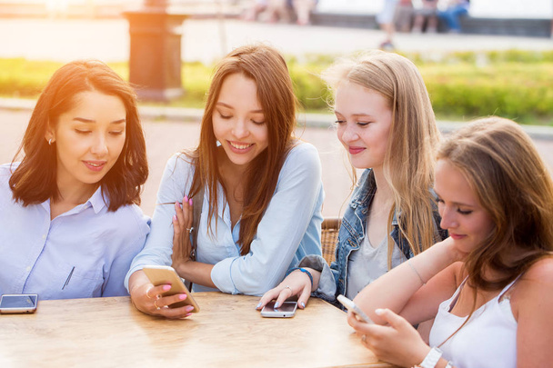 Closeup of four women using smartphones outdoor - 写真・画像