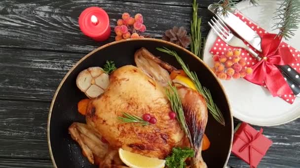 whole roast chicken, branch of a Christmas tree, candle on a wooden background slow-motion - Footage, Video