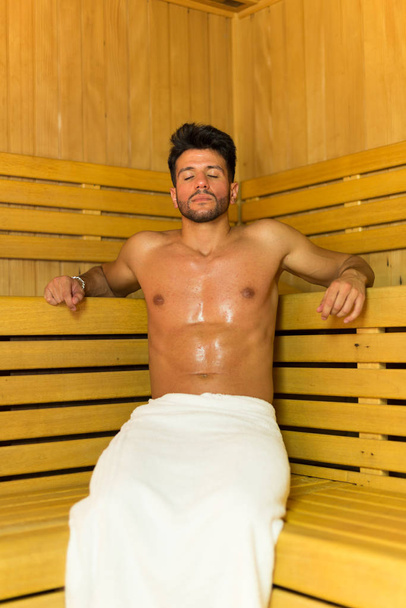 Smiling man having a sauna bath in a steam room - Фото, зображення