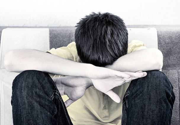 Monochromatic Photo of Sad Young Man on the Sofa - Zdjęcie, obraz