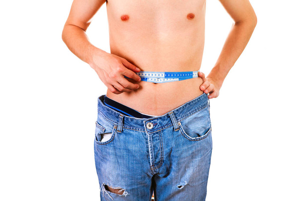 Skinny Man measure his Waist on the White Background - Photo, image