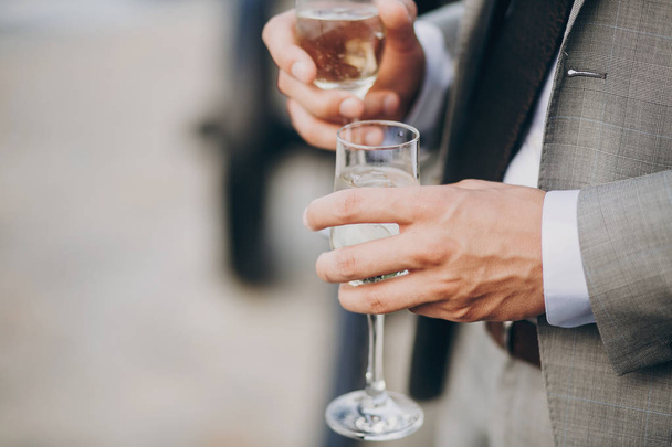 hands of stylish people cheering with glasses of champagne, luxury wedding reception, rich celebration.  guests toasting at christmas luxury celebration feast - Φωτογραφία, εικόνα