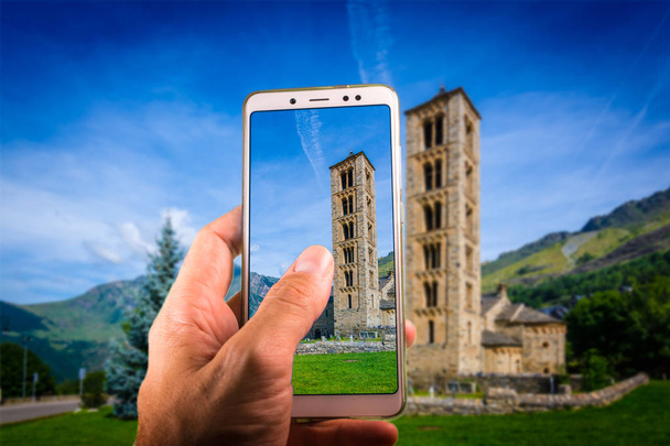 Taking a picture with a smartphone in Belfry and church of Sant Climent de Taull, Spain.Catalan Romanesque Churches of the Vall de Boi are declared a UNESCO World Heritage Site Ref 988 - Photo, Image