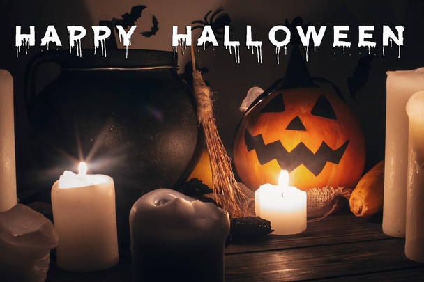 Jack o lantern, Witch cauldron, pumpkin, candles, broom and bats on dark background - Photo, Image