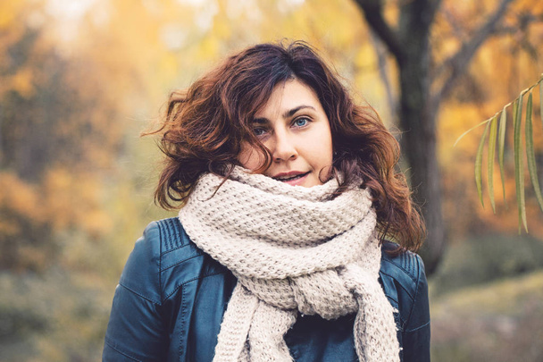 Real woman portrait. Autumn woman in fall park outdoors - 写真・画像