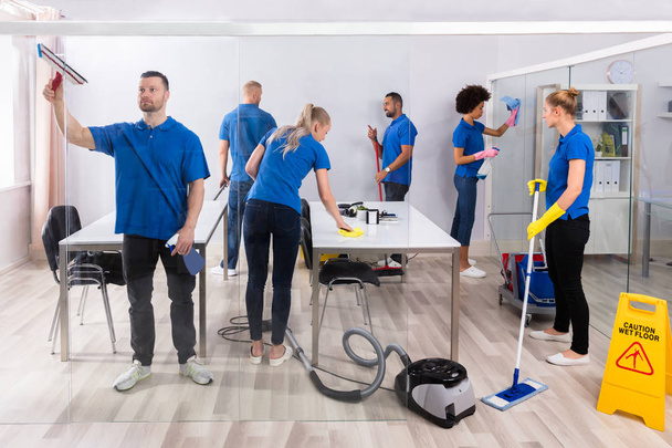 Group Of Skilled Young Janitors In Uniform Cleaning Office - Fotoğraf, Görsel