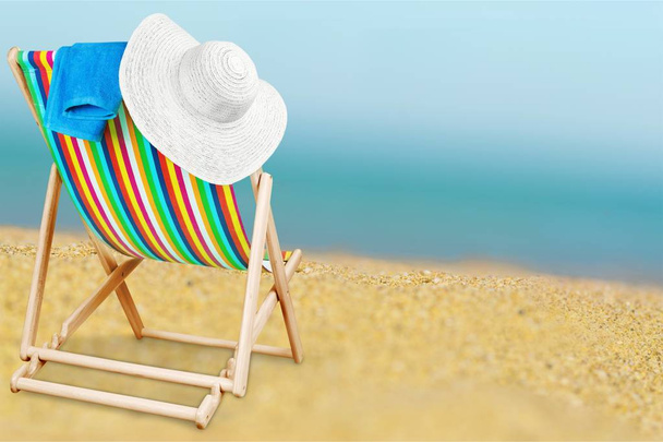 Wooden chaise lounge chair on sandy beach  - Фото, зображення