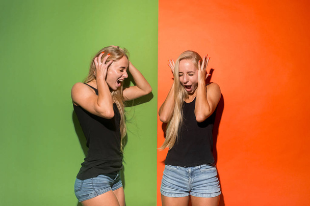 The young emotional angry women screaming on studio background - Foto, Imagen