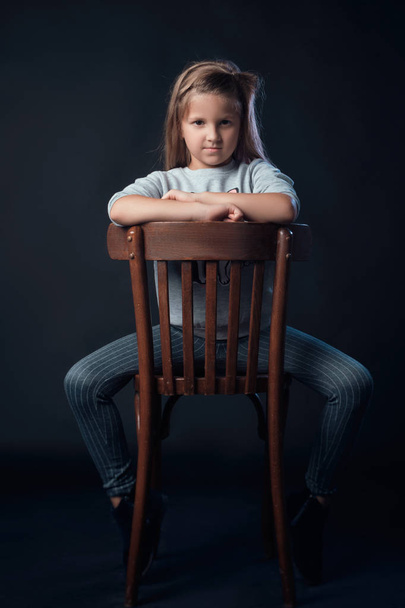 the child in the Studio posing in fashionable clothes - Фото, изображение