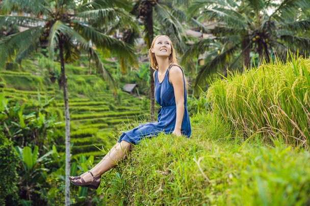 Young woman sitting at Green cascade rice field plantation, Bali, Indonesia  - Фото, изображение
