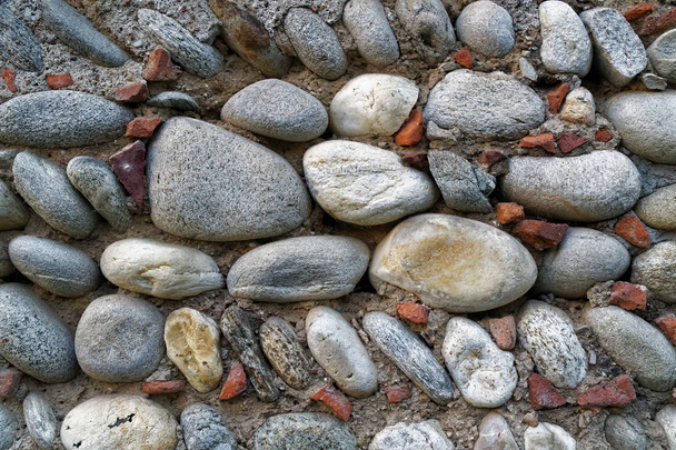Pebbles ancient wall background,closeup big stones. - Photo, Image