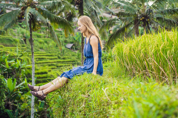 Young woman sitting at Green cascade rice field plantation, Bali, Indonesia  - Φωτογραφία, εικόνα