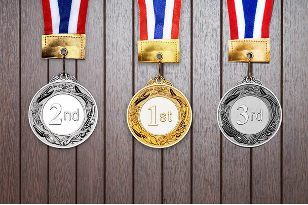 Gold, silver and bronze medals on wooden background  - Photo, Image