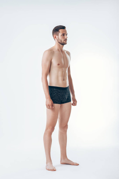 Full length portrait of young sexy muscular male model in underwear.  Man beauty - Foto, Imagen