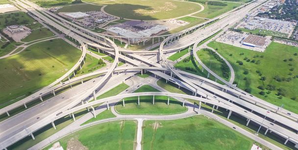 Panorama vertical aerial Interstate 10 or Katy freeway massive intersection, stack interchange, elevated road junction overpass cloud blue sky. Top view metropolitan area of Katy, Texas, USA - Photo, Image