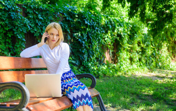 Sales manager works in park. Woman with laptop works outdoors. Best sales managers always possess these skills. Call sales techniques. Successful call. Freelancer sales manager calling client - Fotografie, Obrázek