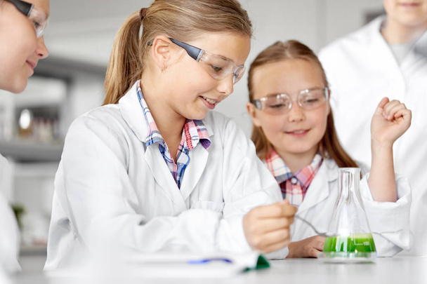 kids with test tube studying chemistry at school - Photo, image