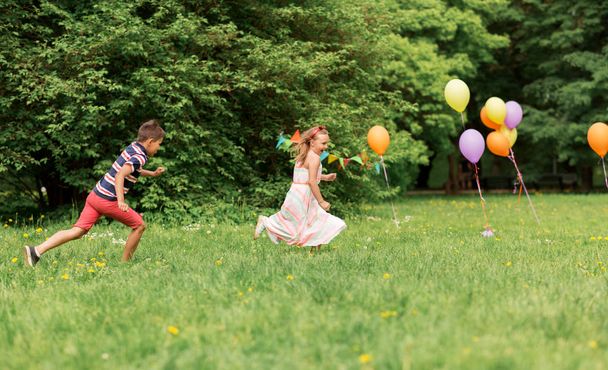 happy kids playing tag game at birthday party - Fotoğraf, Görsel